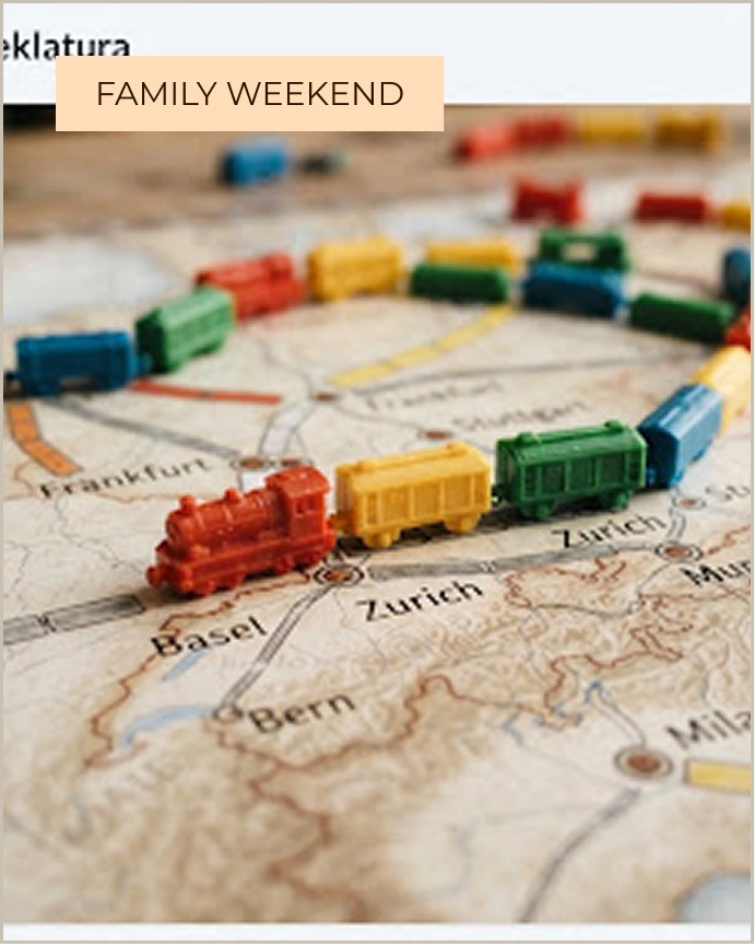 Miniature plastic train carriages placed along railway routes on a map in the Ticket to Ride board game