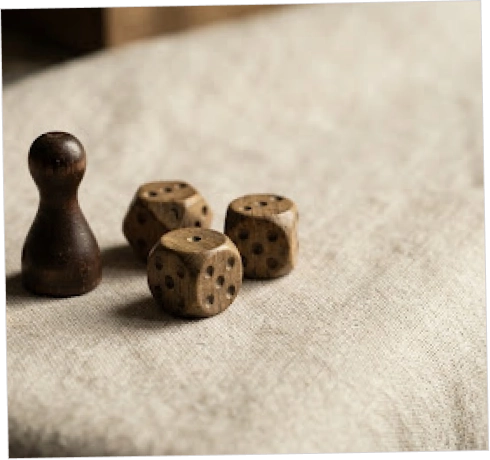 A dark wooden pawn figure and three wooden dice resting on a beige fabric surface